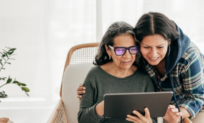 a mother with her daughter looking at options for selling her house for cash